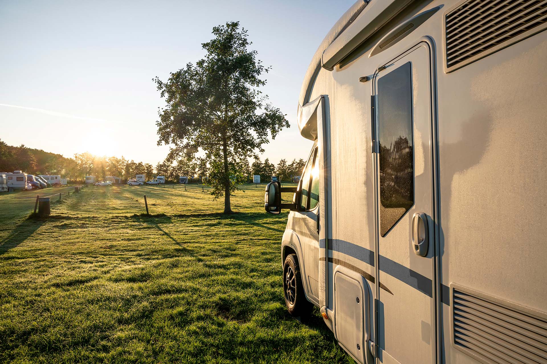 motorhome in detail before rising sun with morning dew against the light